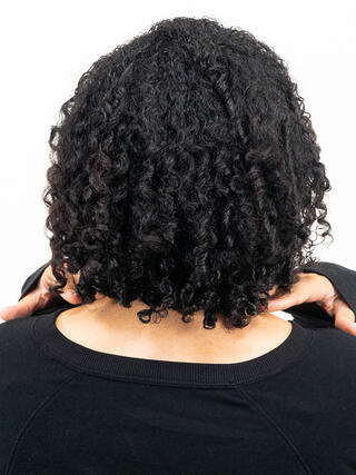 Foto de después: vista trasera de una mujer con cabello corto y negro de color uniforme.